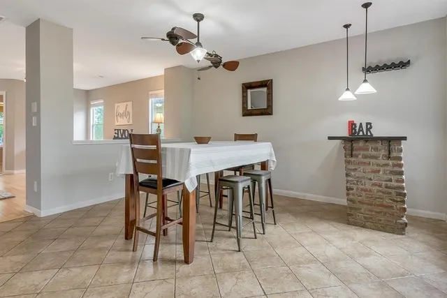 a view of a dining room with furniture and chandelier