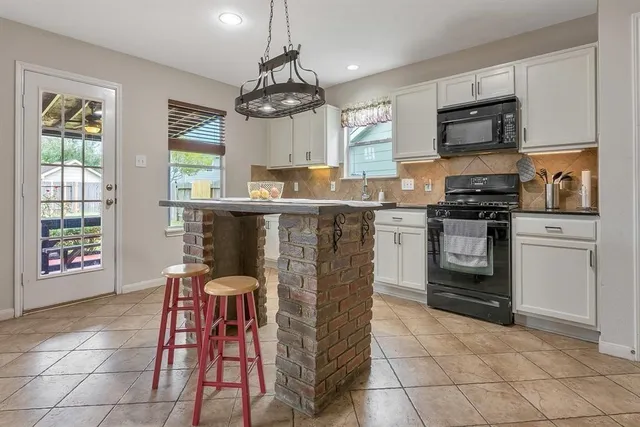a view of kitchen and dining area with chandelier
