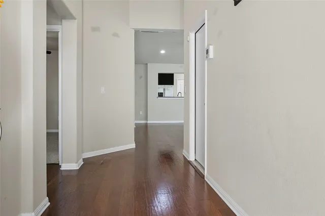 a view of a hallway with wooden floor