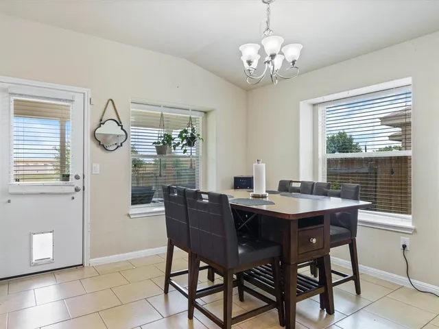 a view of a dining room with furniture wooden floor and chandelier