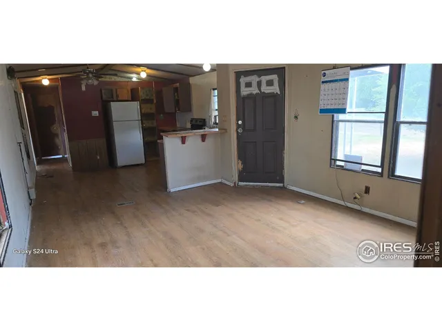 a view of a living room with kitchen natural appliances