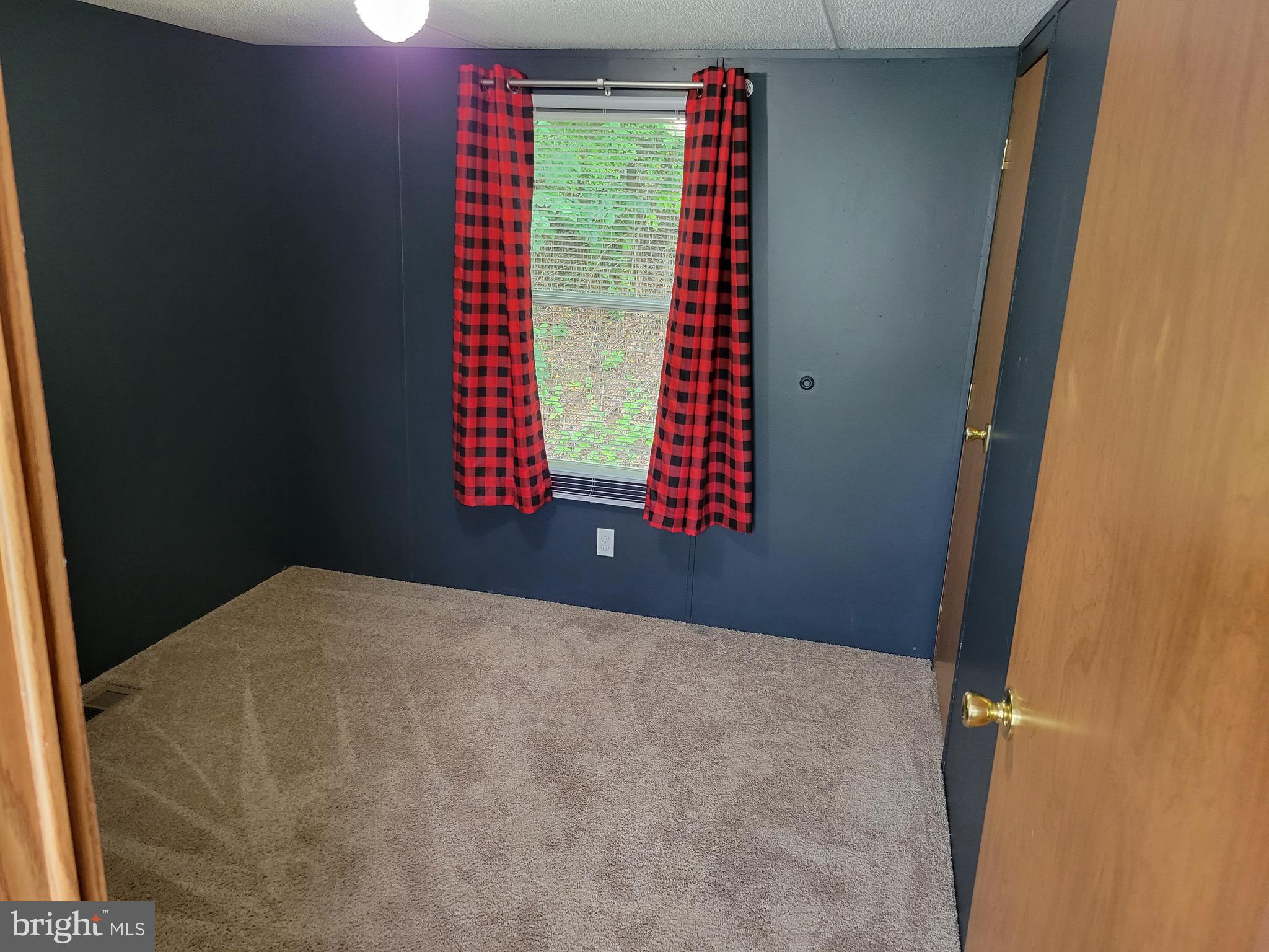 164 Jimtown Road Berkeley Springs, WV 25411 - Photo 11 of 15 a view of an empty room with a window