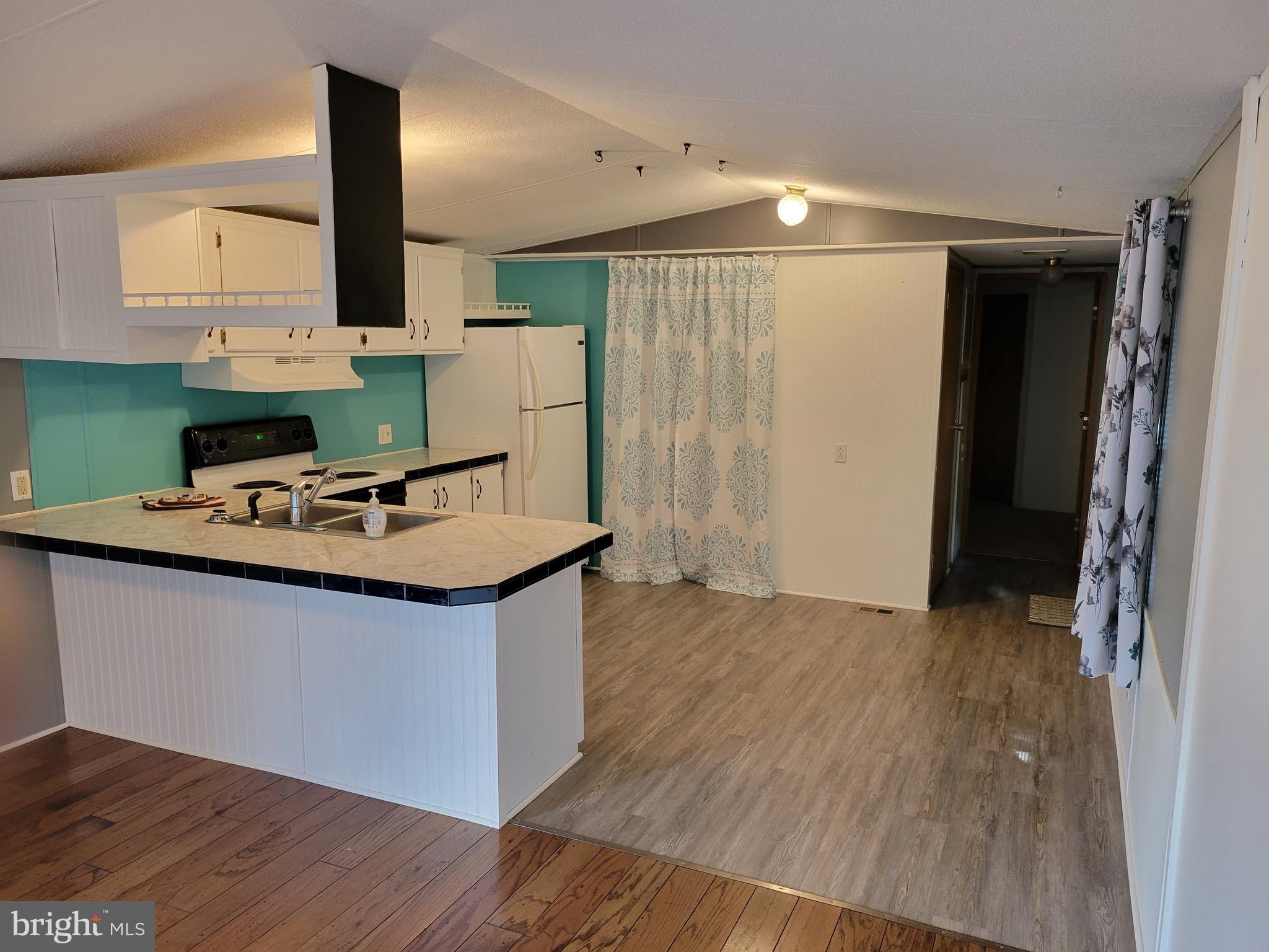 164 Jimtown Road Berkeley Springs, WV 25411 - Photo 6 of 15 a kitchen with stainless steel appliances granite countertop a sink stove and refrigerator