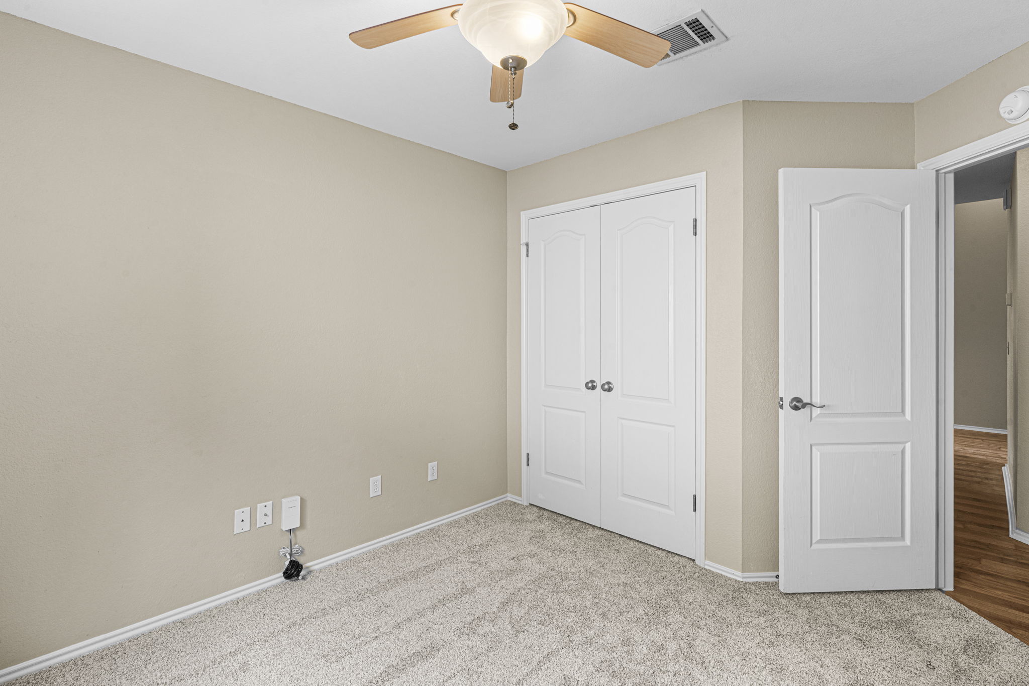 7172 Ridge Oak Road Austin, TX 78749 - Photo 35 of 40 A well-lit bedroom with carpeted floors, dual closets, and a convenient ceiling fan.