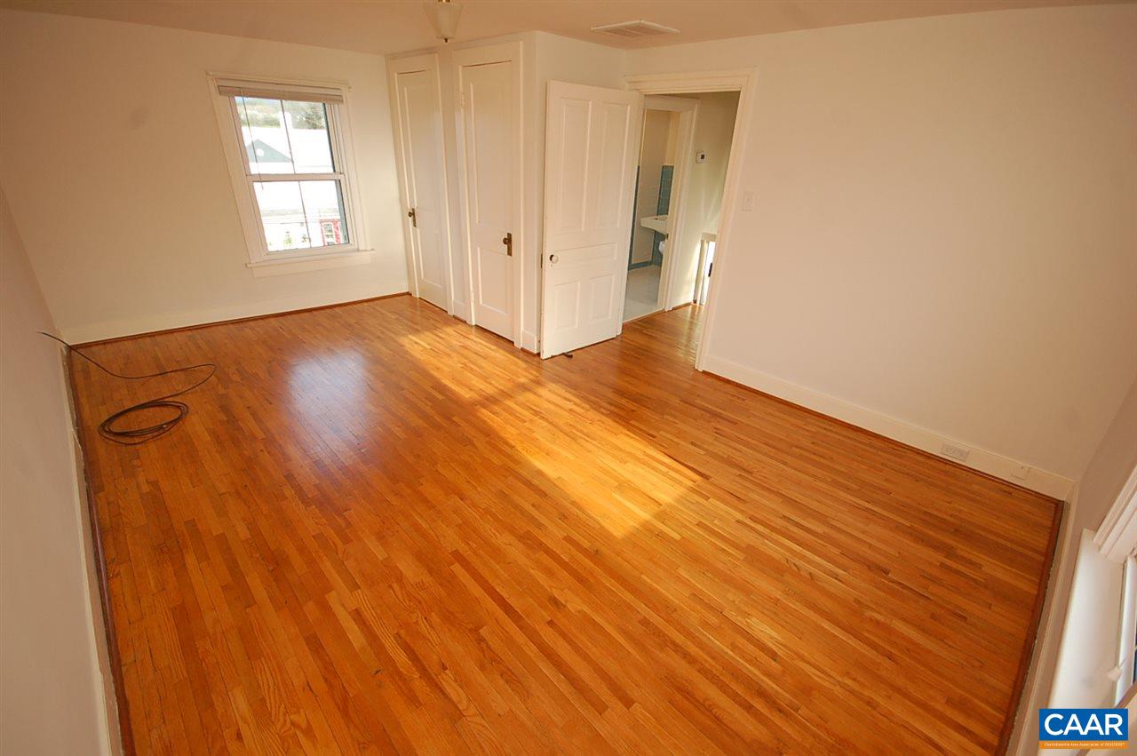 32 Madison Road Stanardsville, VA 22973 - Photo 25 of 50 a view of an empty room with wooden floor and a window
