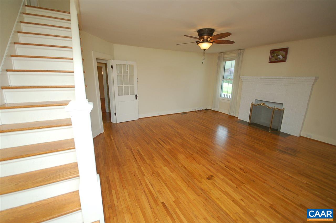 32 Madison Road Stanardsville, VA 22973 - Photo 10 of 50 a view of an empty room with wooden floor and a chandelier