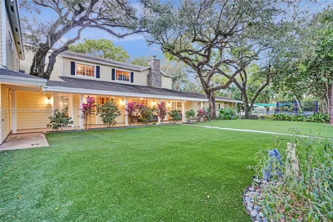 a view of a house with a big yard and garden