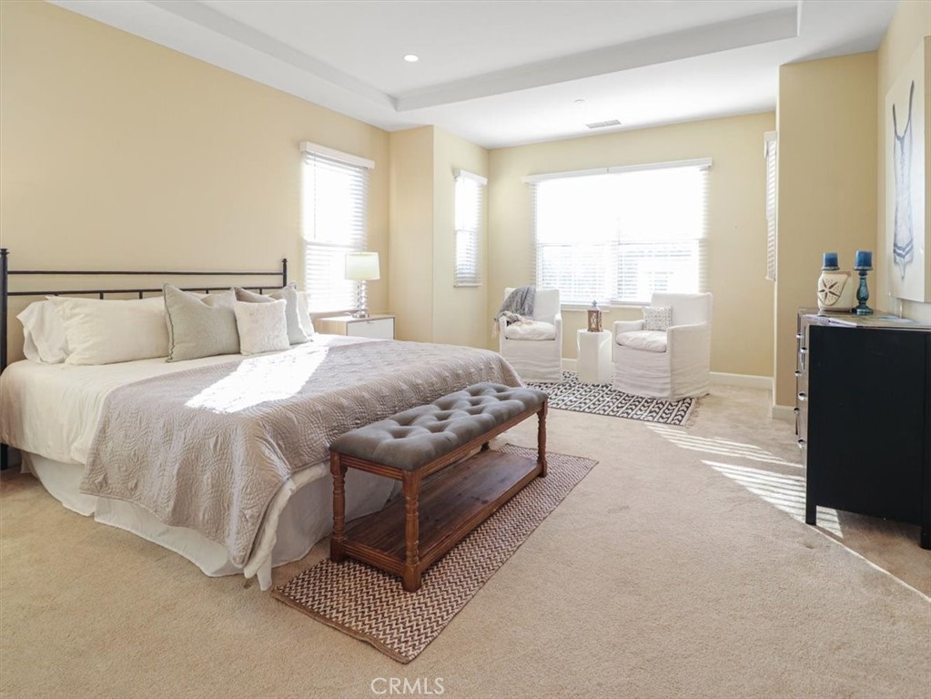 101 Omar Irvine, CA 92620 - Photo 30 of 42 a spacious bedroom with a bed a table and large window