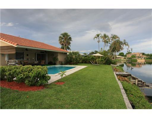 1966 Sharon Street Boca Raton, FL 33486 - Photo 1 of 17 a front view of a house with a yard