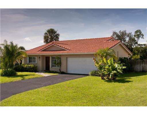 1966 Sharon Street Boca Raton, FL 33486 - Photo 3 of 17 a front view of a house with a yard and a garage