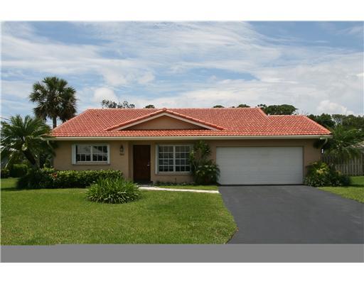 1966 Sharon Street Boca Raton, FL 33486 - Photo 5 of 17 a front view of a house with garden