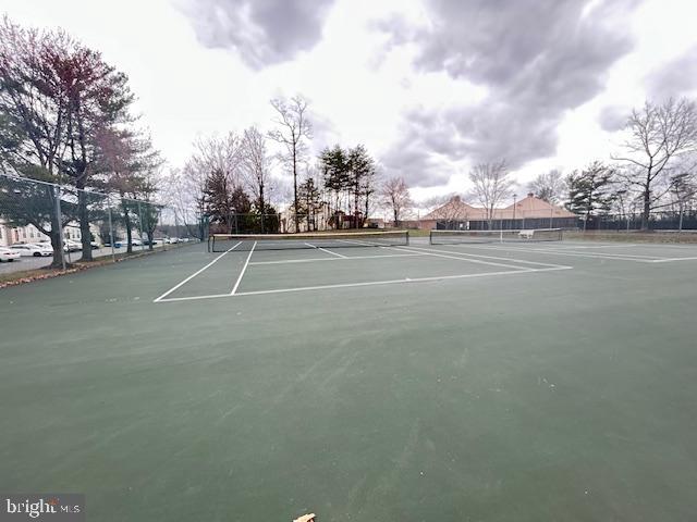 6443 McCoy Road Centreville, VA 20121 - Photo 28 of 28 Serene tennis courts under moody skies.