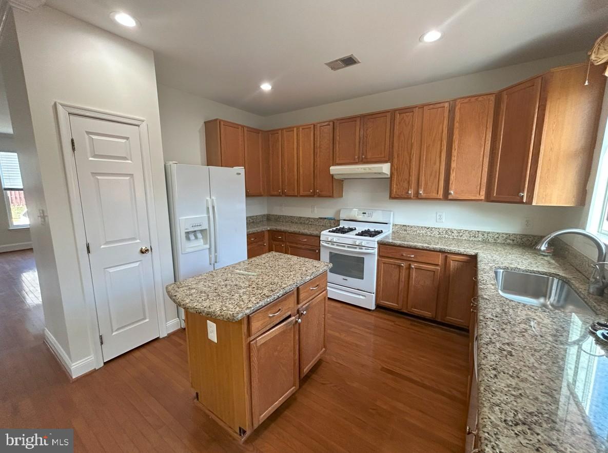 6443 McCoy Road Centreville, VA 20121 - Photo 6 of 28 Modern kitchen with warm wood cabinetry.