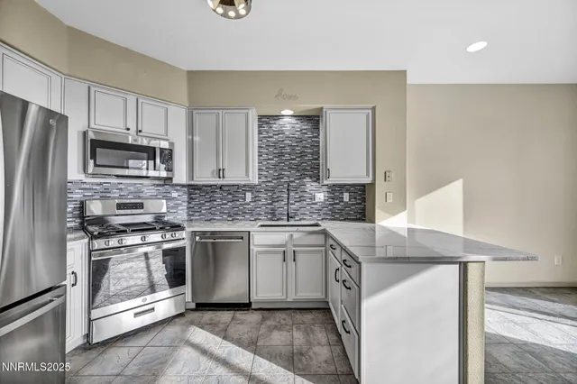a kitchen with granite countertop a stove microwave and cabinets
