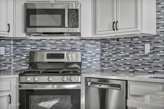 a kitchen with granite countertop a stove and a sink