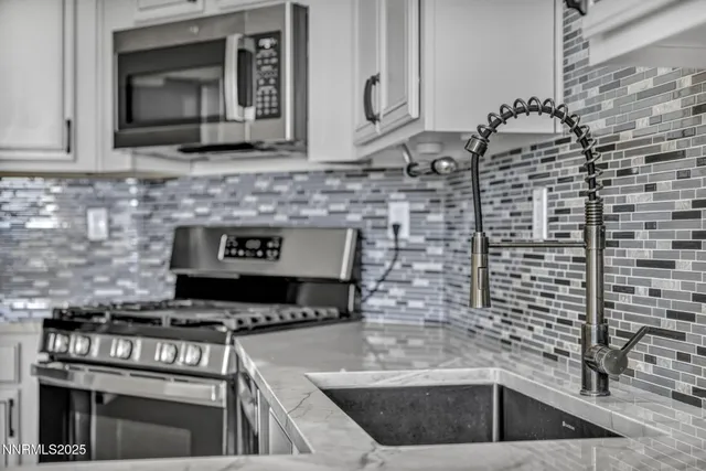 a kitchen with stainless steel appliances a refrigerator and a stove top oven