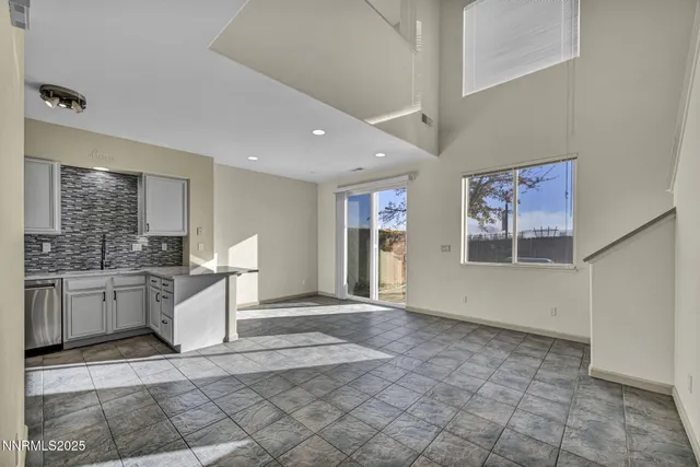 a view of a kitchen with a sink and a refrigerator