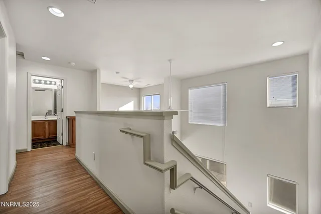 a view of a hallway with wooden floor and closet