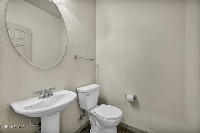a living room with stainless steel appliances kitchen island granite countertop a refrigerator and cabinets