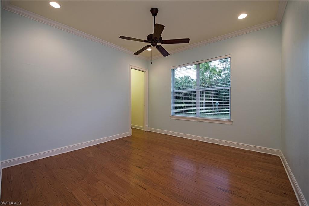 3883 North Road Naples, FL 34104 - Photo 13 of 20 a view of room with wooden floor ceiling fan and window