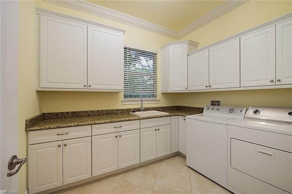 3883 North Road Naples, FL 34104 - Photo 16 of 20 a kitchen with granite countertop white cabinets and sink