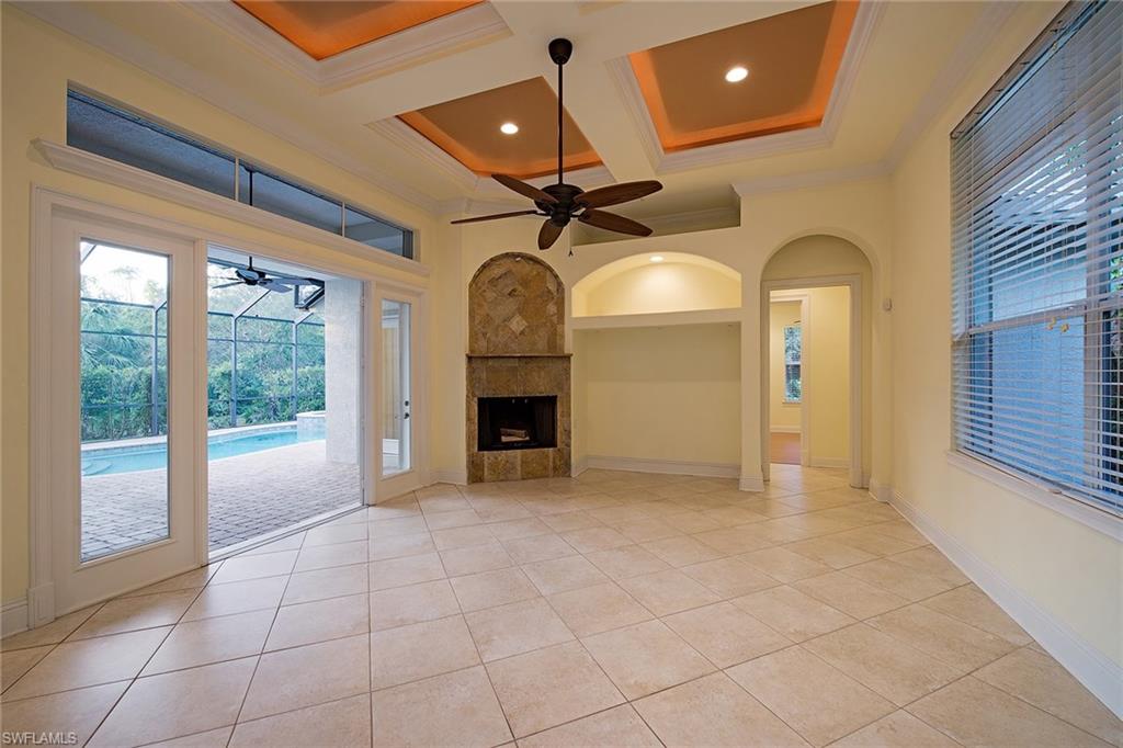 3883 North Road Naples, FL 34104 - Photo 4 of 20 a view of a livingroom with a fireplace and a chandelier