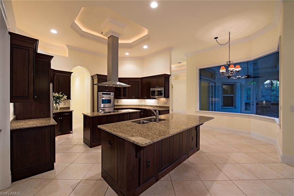 3883 North Road Naples, FL 34104 - Photo 7 of 20 a kitchen with stainless steel appliances granite countertop a stove a refrigerator a sink and a refrigerator