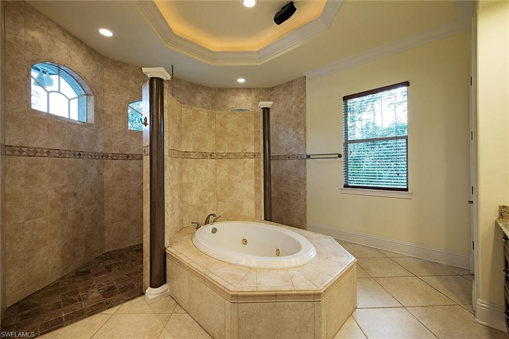 3883 North Road Naples, FL 34104 - Photo 9 of 20 a bathroom with a tub and a shower