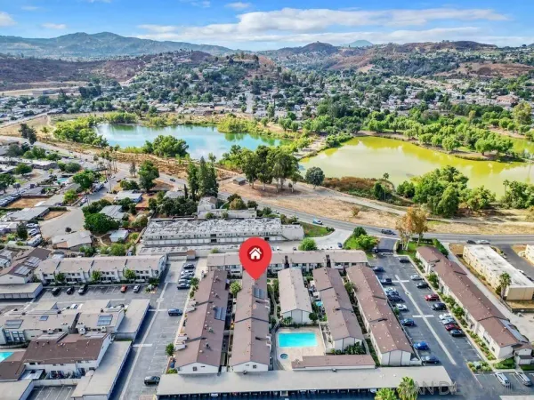 an aerial view of residential houses with outdoor space and river