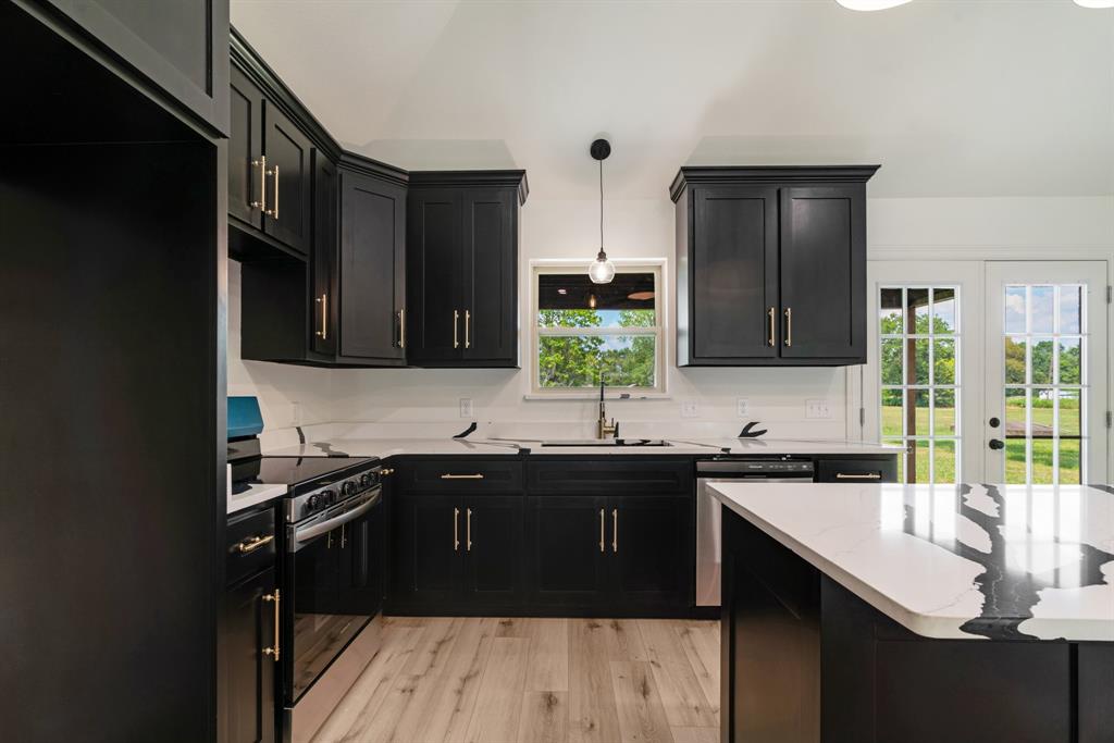 306 Sunset Street Roxton, TX 75477 - Photo 15 of 26 a kitchen with a sink and cabinets