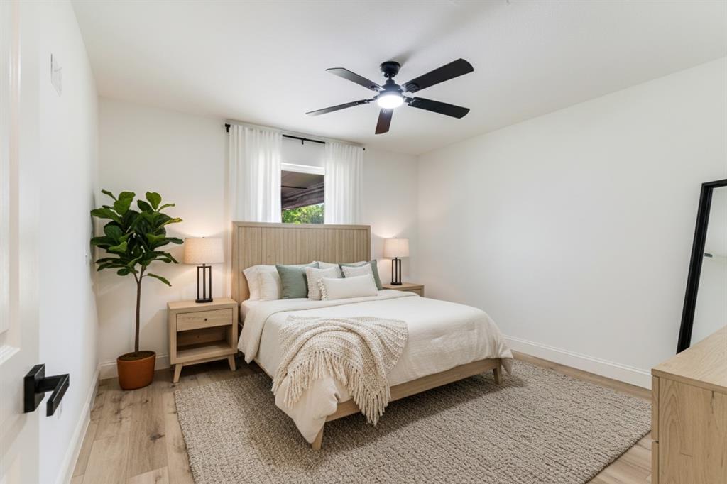 306 Sunset Street Roxton, TX 75477 - Photo 16 of 26 a bedroom with a bed and a potted plant