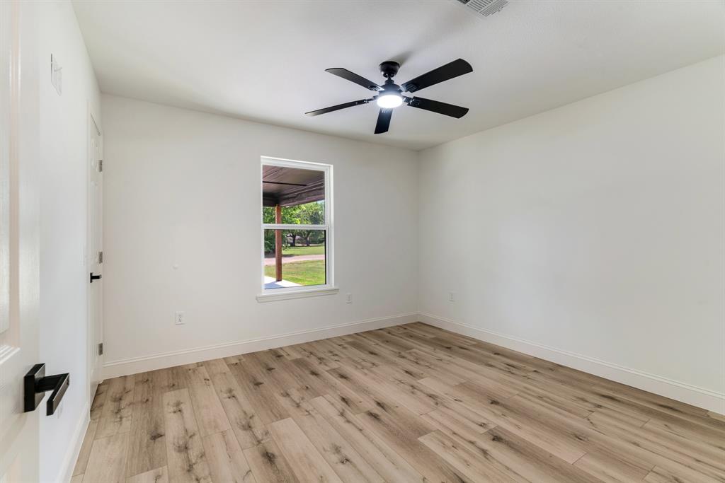 306 Sunset Street Roxton, TX 75477 - Photo 17 of 26 wooden floor in an empty room
