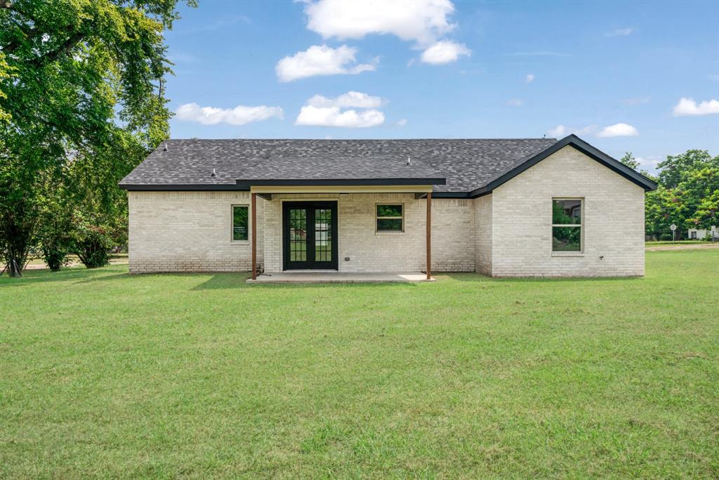 306 Sunset Street Roxton, TX 75477 - Photo 25 of 26 a view of a house with a backyard