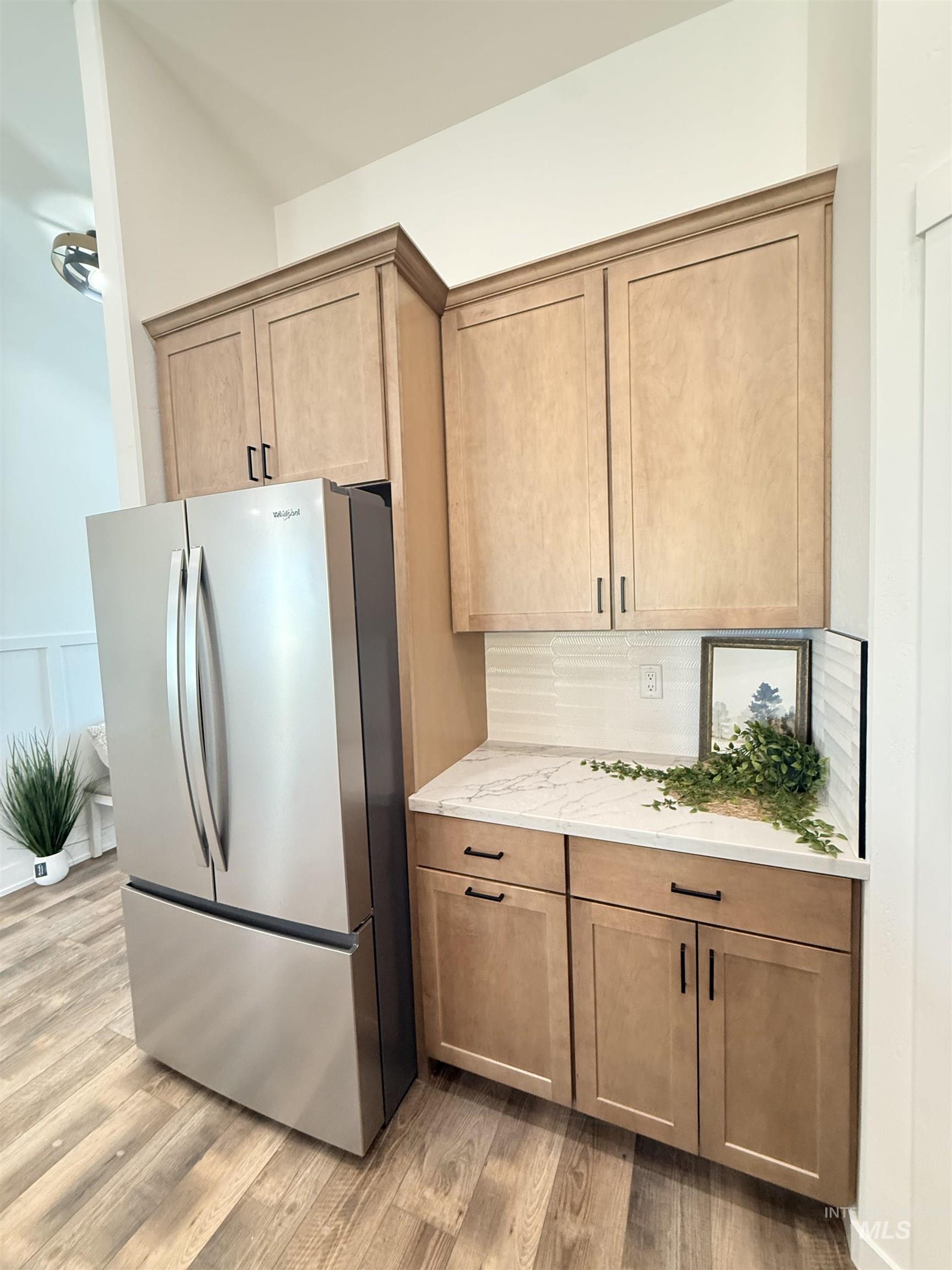 1220 Bronze Rupert, ID 83350 - Photo 11 of 30 Kitchen area featuring light wood cabinetry, a white countertop with subtle veining, and a horizontal white tile backsplash