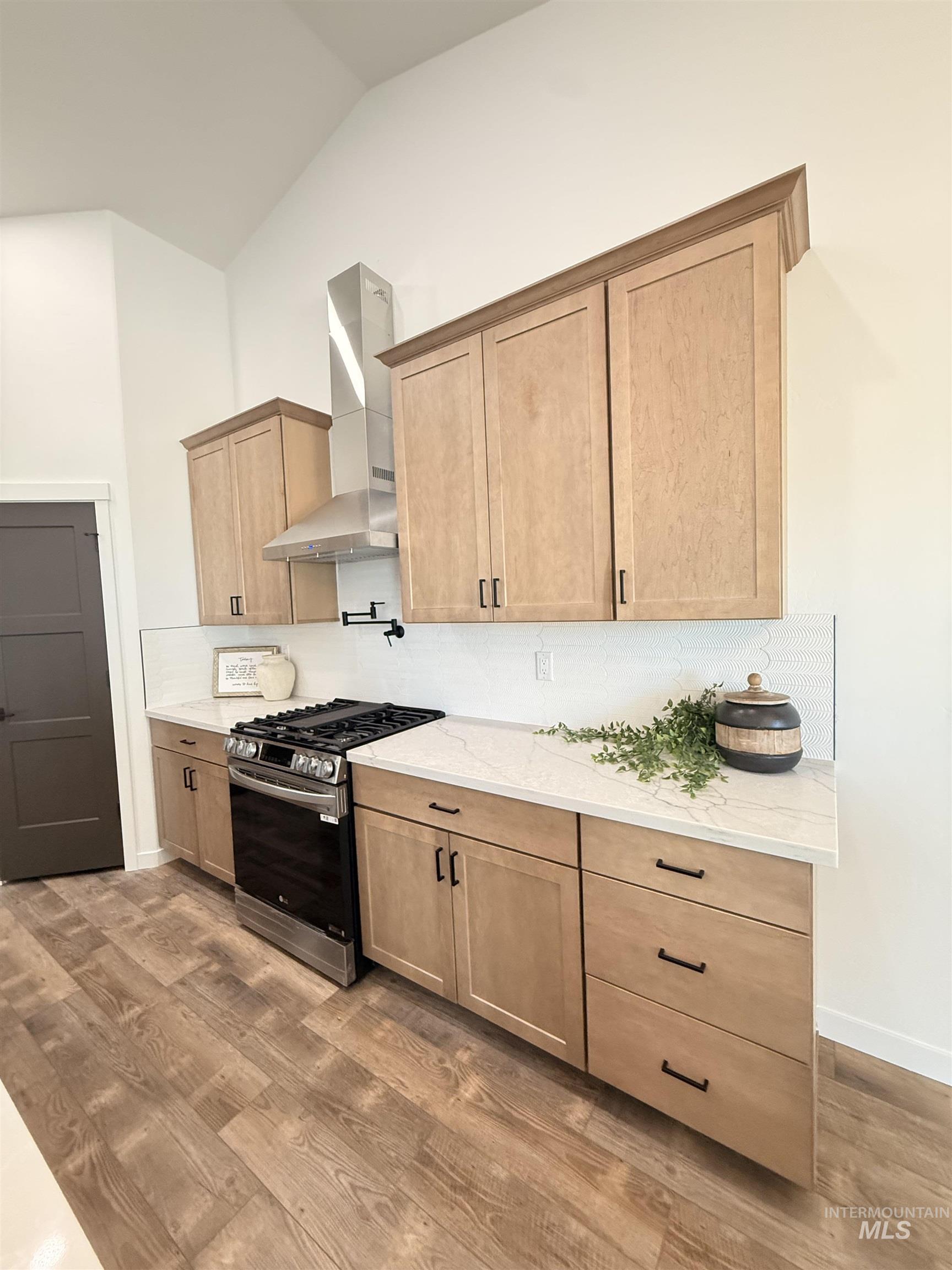1220 Bronze Rupert, ID 83350 - Photo 15 of 30 Kitchen featuring light wood-finish cabinetry with black hardware, white countertops, and a white subway tile backsplash