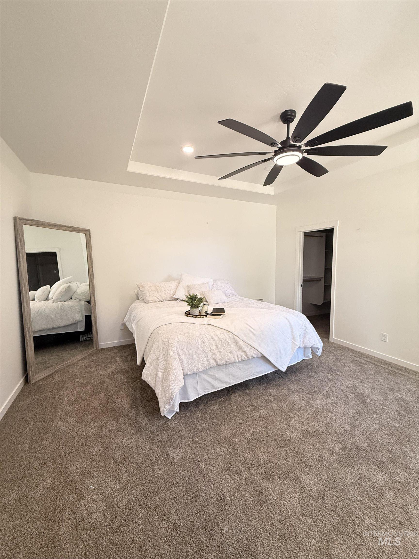 1220 Bronze Rupert, ID 83350 - Photo 16 of 30 Spacious room featuring a tray ceiling, recessed lighting, and a modern black ceiling fan with integrated lighting