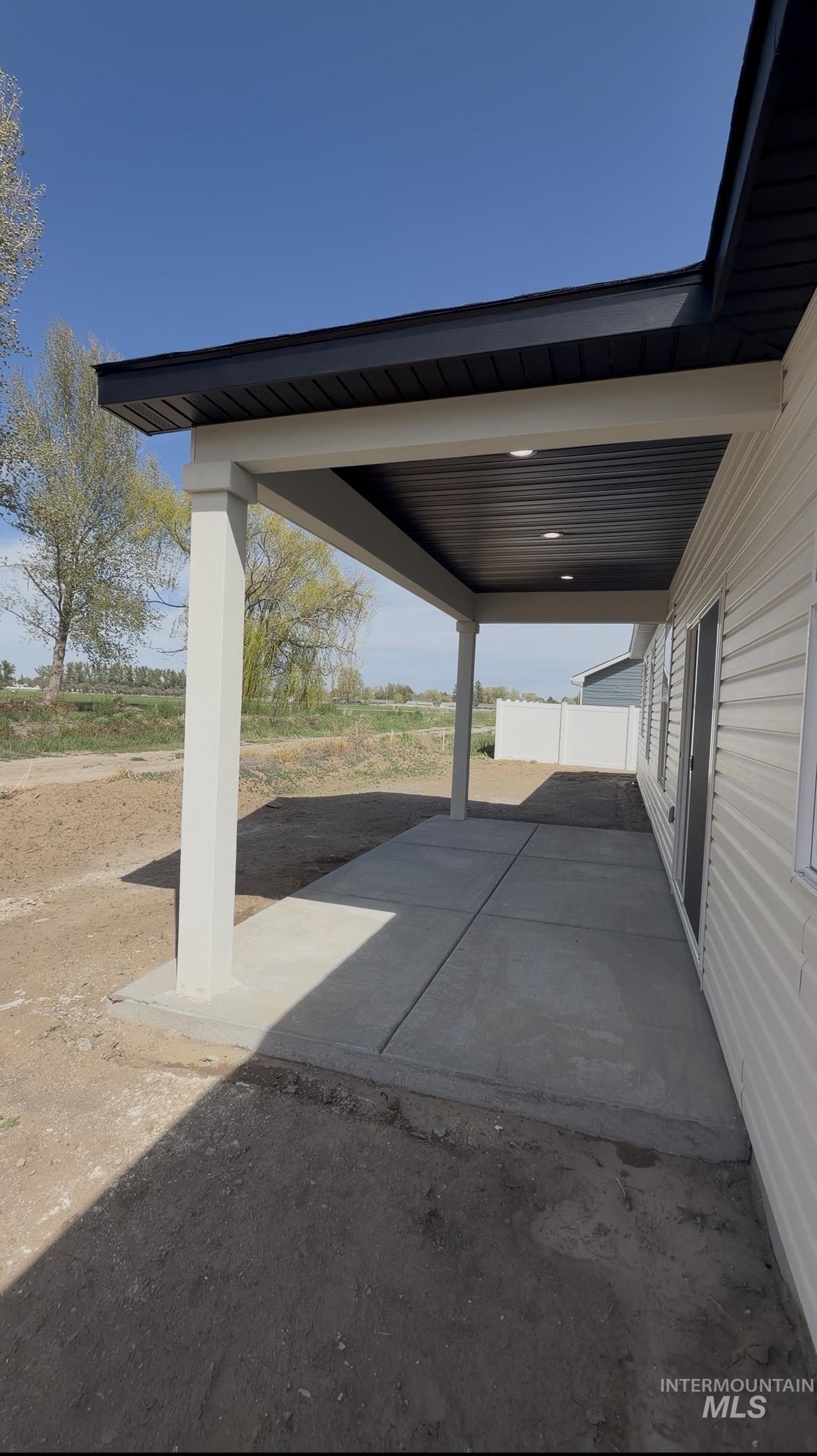 1220 Bronze Rupert, ID 83350 - Photo 28 of 30 Covered concrete patio featuring recessed lighting, a white vinyl exterior, and a black soffit