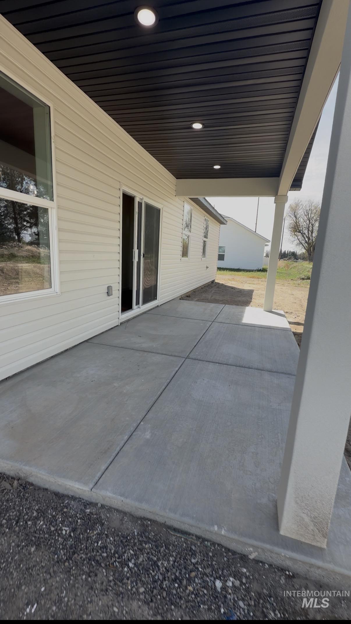 1220 Bronze Rupert, ID 83350 - Photo 29 of 30 Covered patio featuring a black soffit ceiling with recessed lighting, concrete slab, and vinyl siding exterior