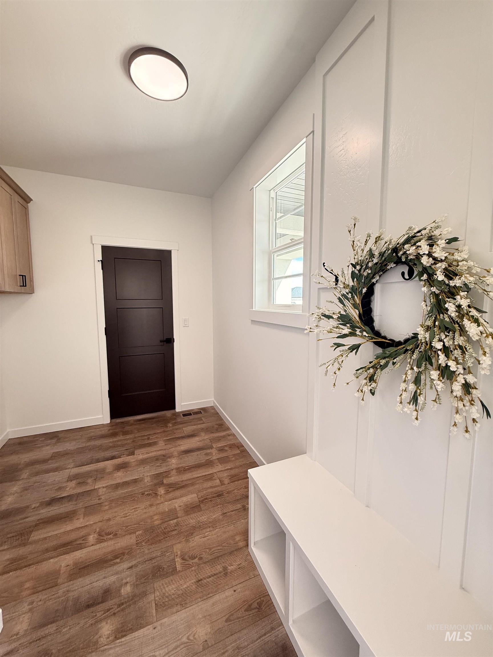1220 Bronze Rupert, ID 83350 - Photo 3 of 30 Entryway featuring wood-finish flooring, white walls, and a built-in storage bench