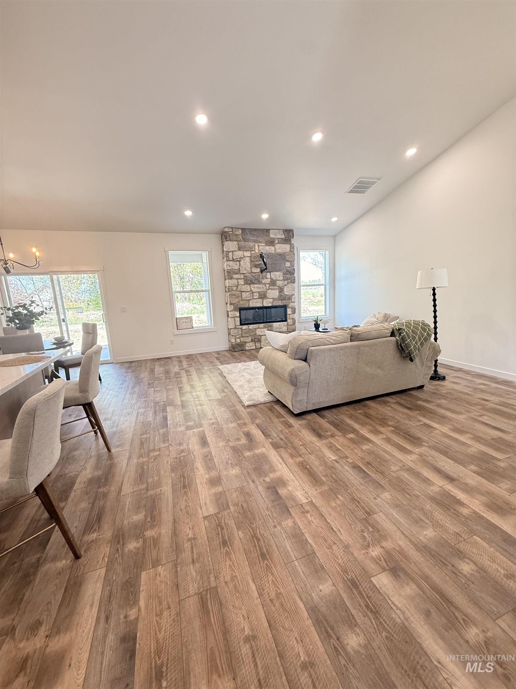 1220 Bronze Rupert, ID 83350 - Photo 6 of 30 Spacious living area featuring high vaulted ceilings, recessed lighting, and wood-finish flooring