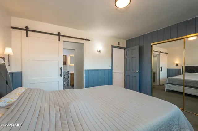 a bedroom with a bed and a mirror