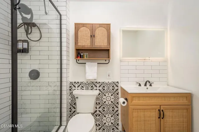 a bathroom with a sink toilet and shower