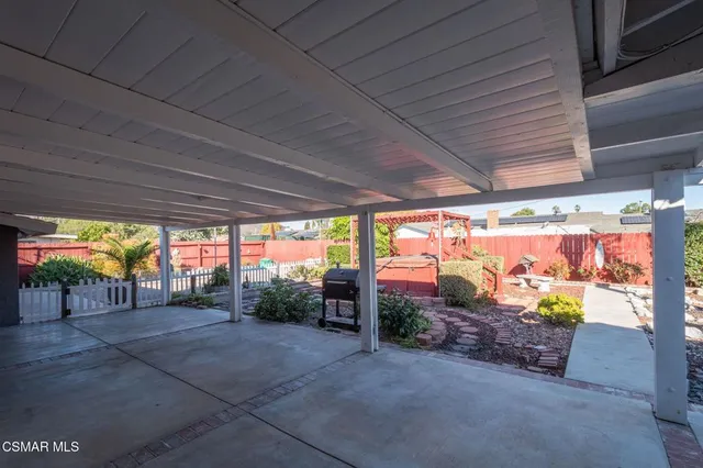 a view of a porch with furniture and a garage
