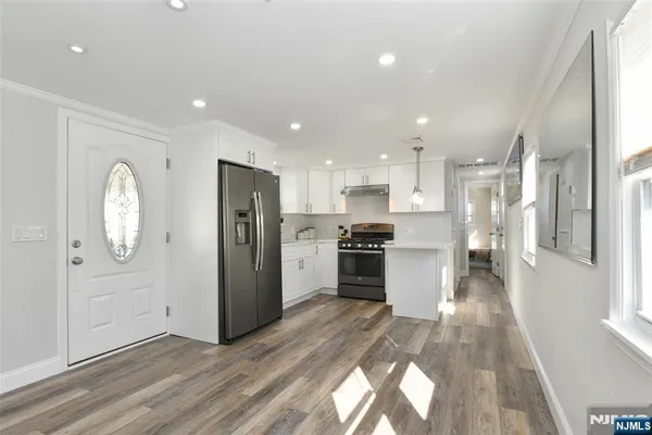 a kitchen with a refrigerator and a sink