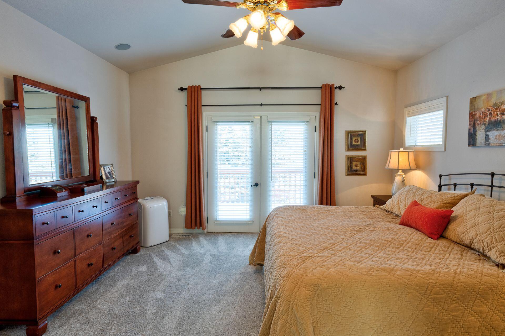 3335 Northeast Stonebrook Loop Bend, OR 97701 - Photo 20 of 29 a spacious bedroom with a bed and a dresser in it