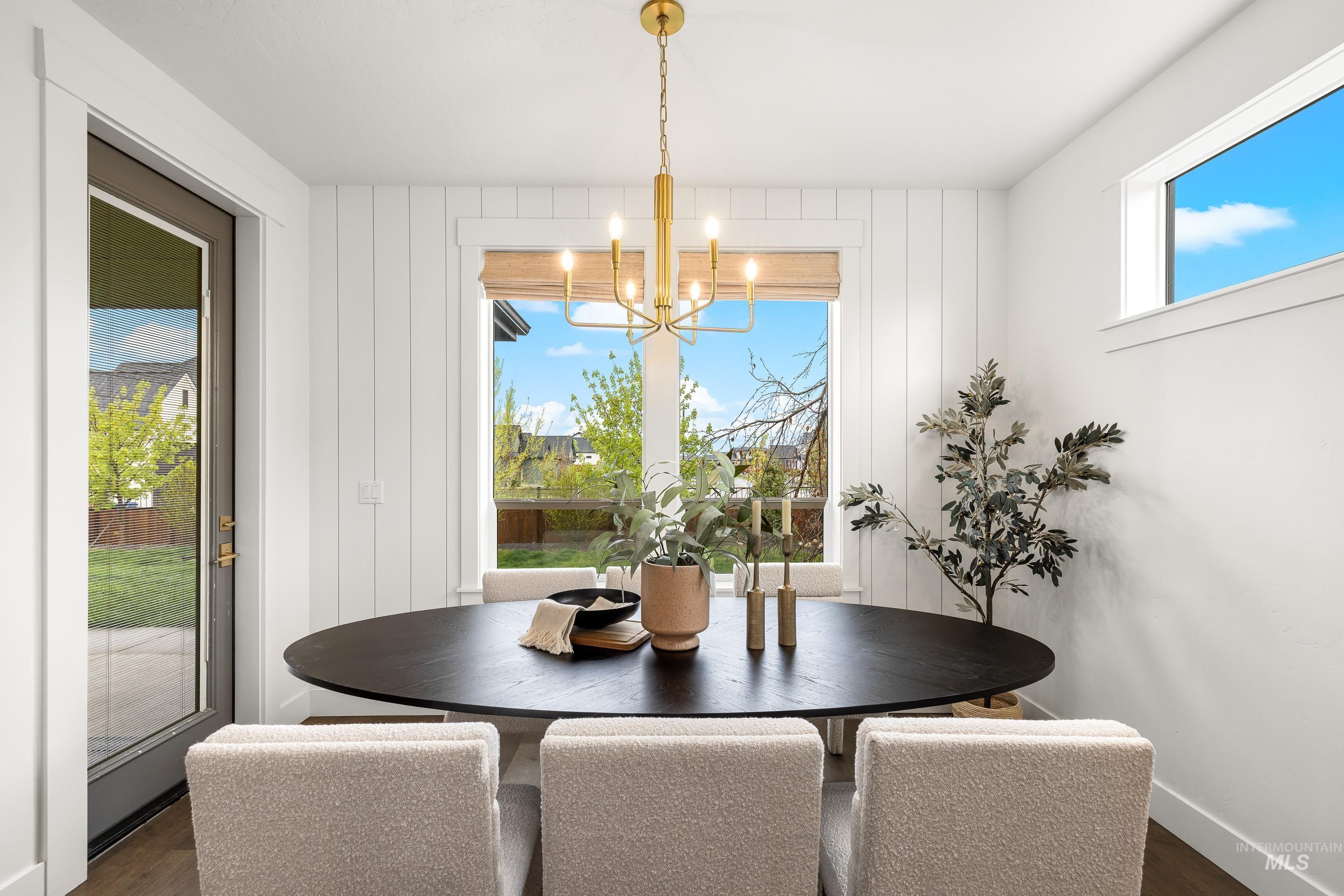 747 South Short Road Eagle, ID 83616 - Photo 19 of 48 Dining space with dark wood-style flooring and a chandelier