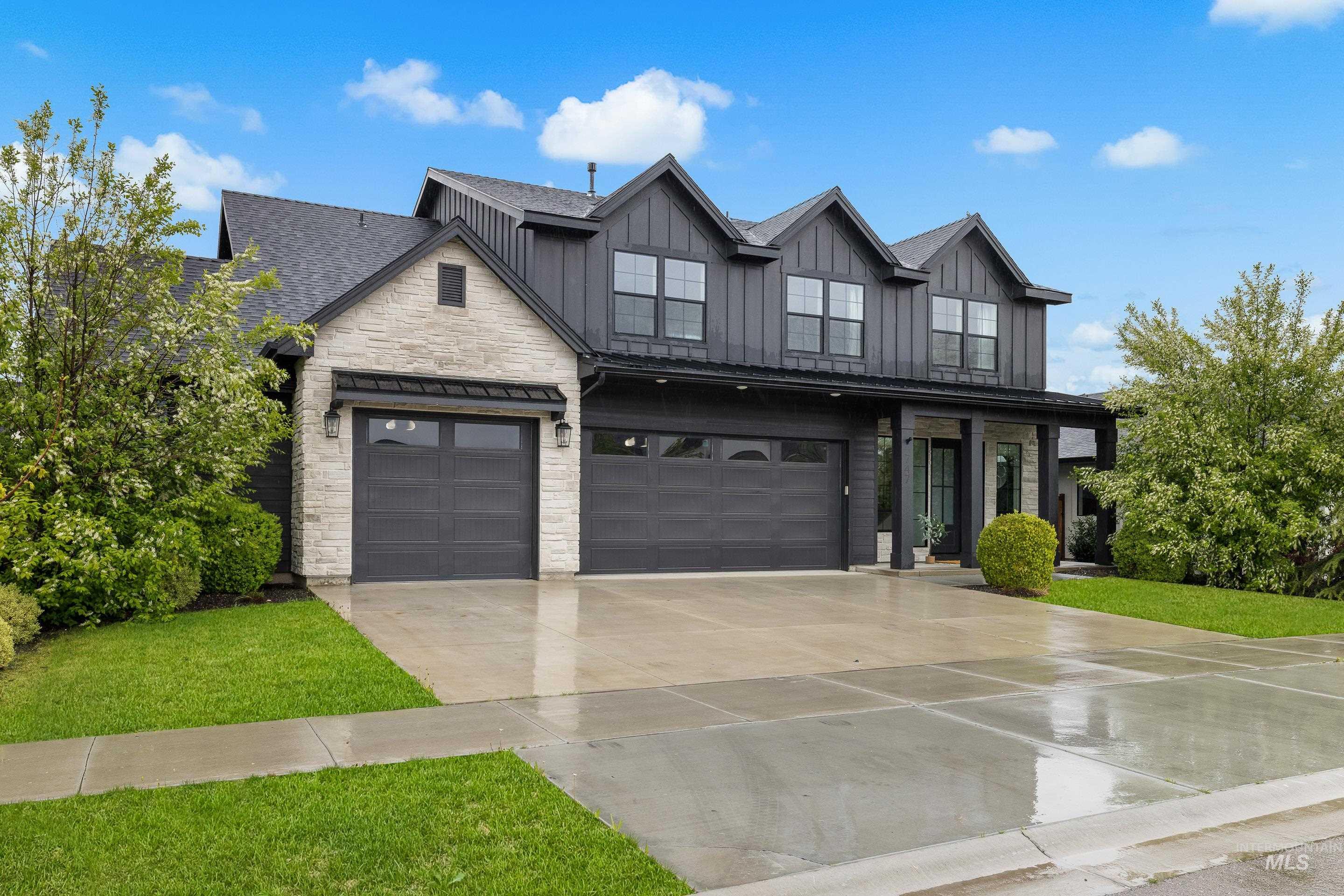 747 South Short Road Eagle, ID 83616 - Photo 2 of 48 Modern inspired farmhouse with stone siding, a front yard, concrete driveway, and board and batten siding