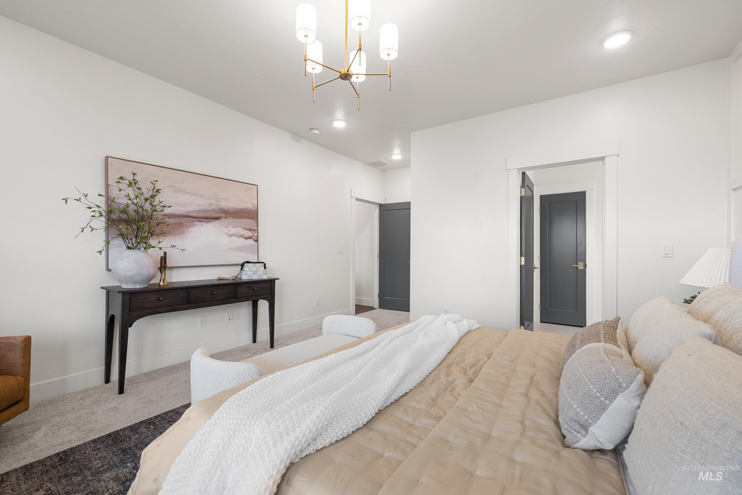 747 South Short Road Eagle, ID 83616 - Photo 22 of 48 Carpeted bedroom featuring baseboards and a chandelier
