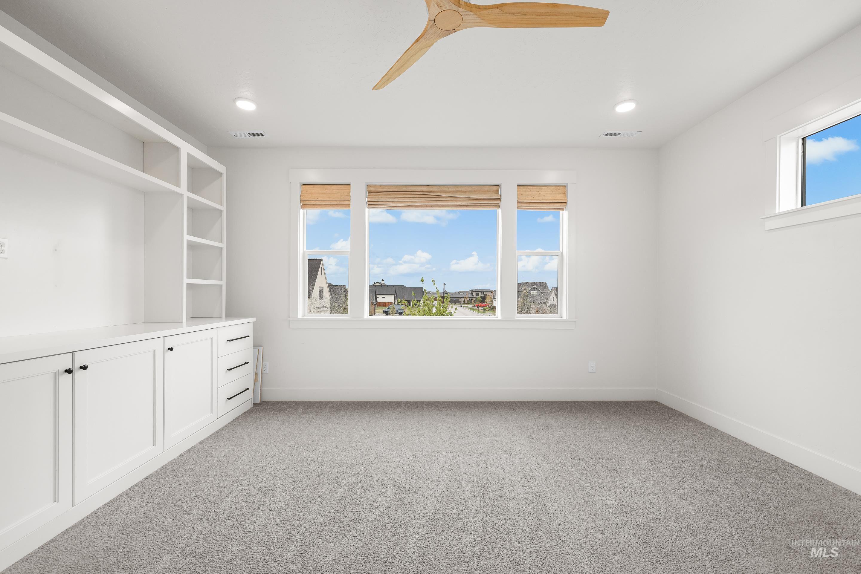 747 South Short Road Eagle, ID 83616 - Photo 30 of 48 Spare room with a ceiling fan and light colored carpet