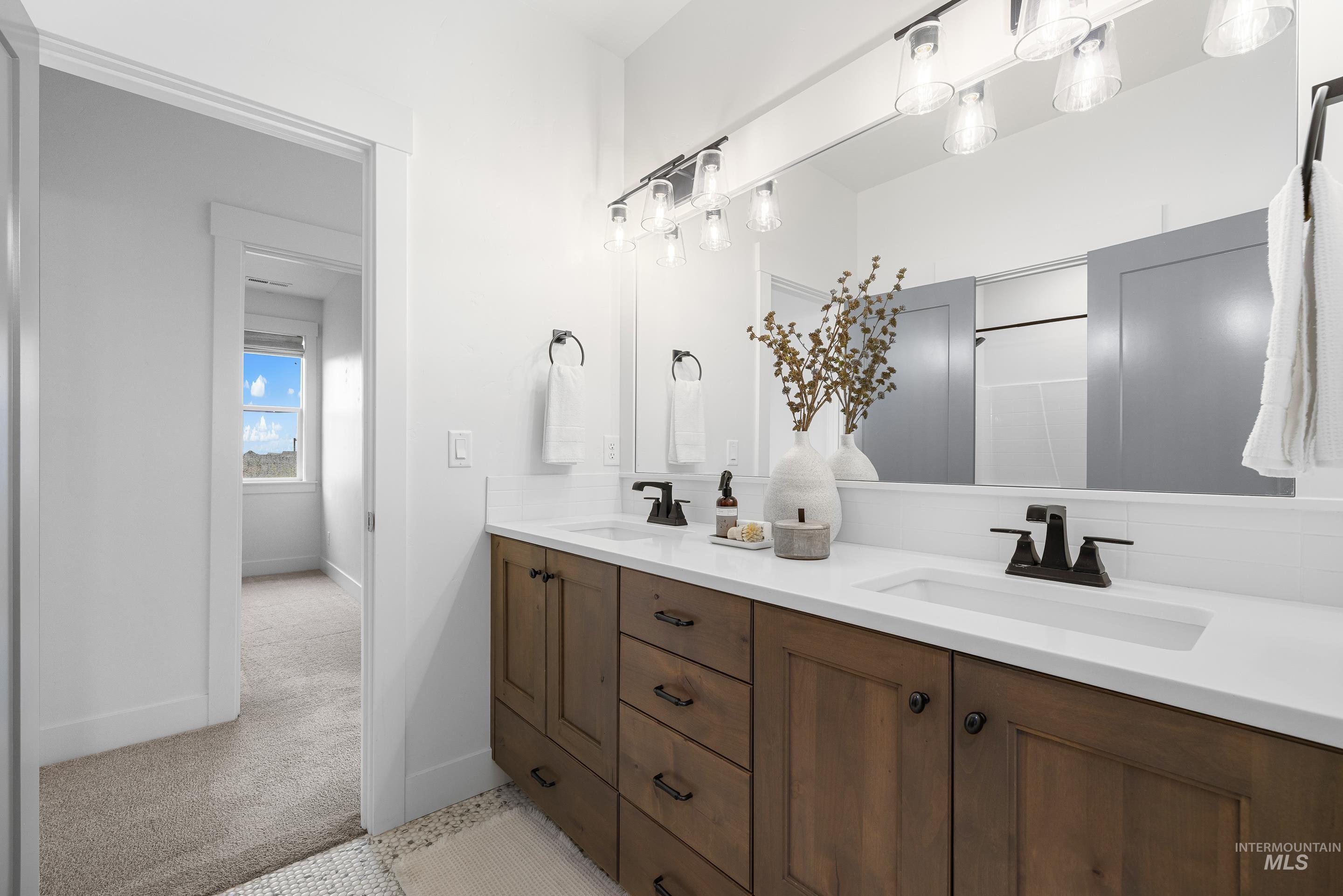 747 South Short Road Eagle, ID 83616 - Photo 32 of 48 Full bathroom with double vanity and light carpet